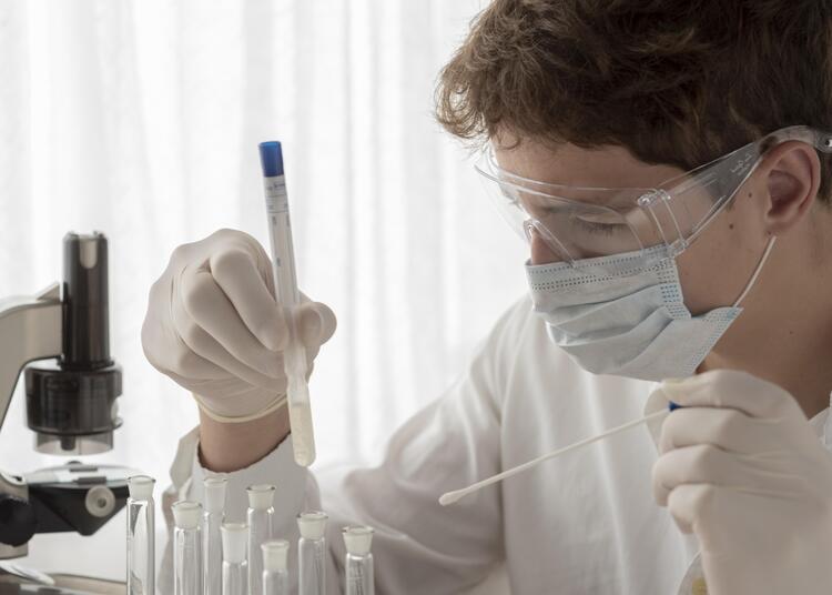close-up-scientist-looking-flask-1