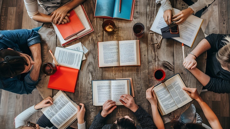 group-friends-are-sitting-around-table-reading-books-they-are-all-wearing-casual-clothes-look-like-they-are-enjoying-their-time-1