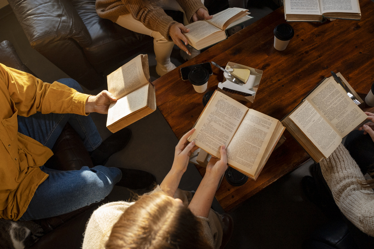 high-angle-people-reading-together-1